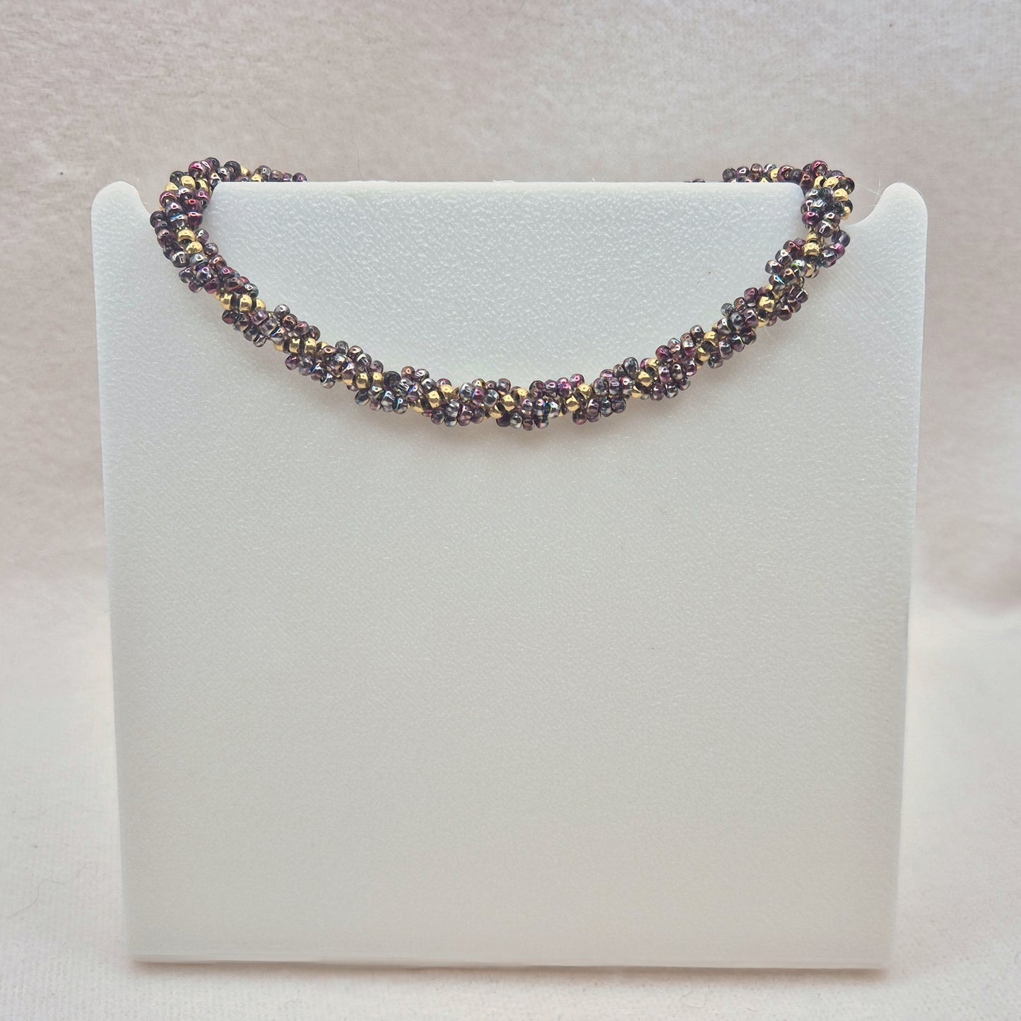 Armkette Spiral in Lila/Gold